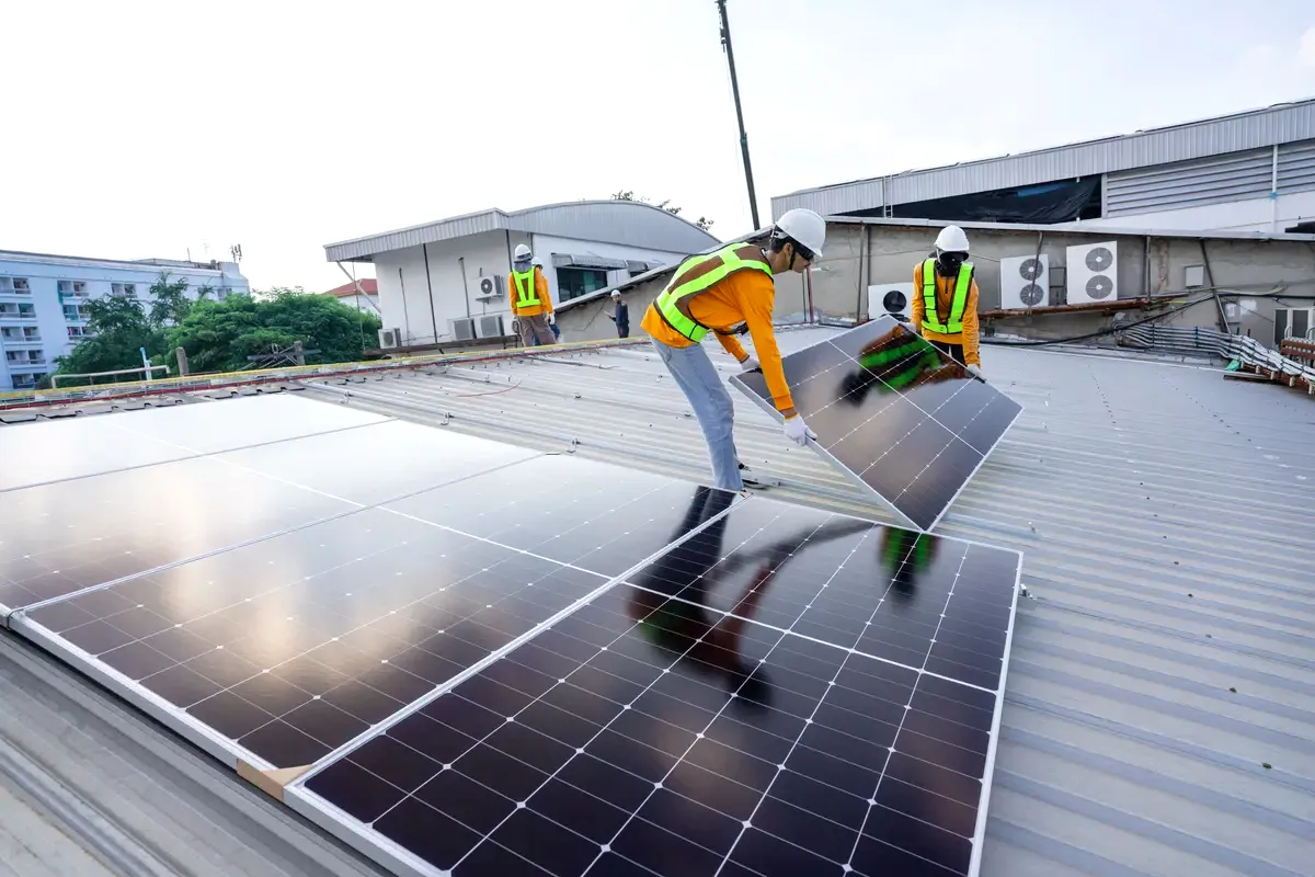 Equipo monta paneles solares en la cubierta de una nave industrial de Barcelona